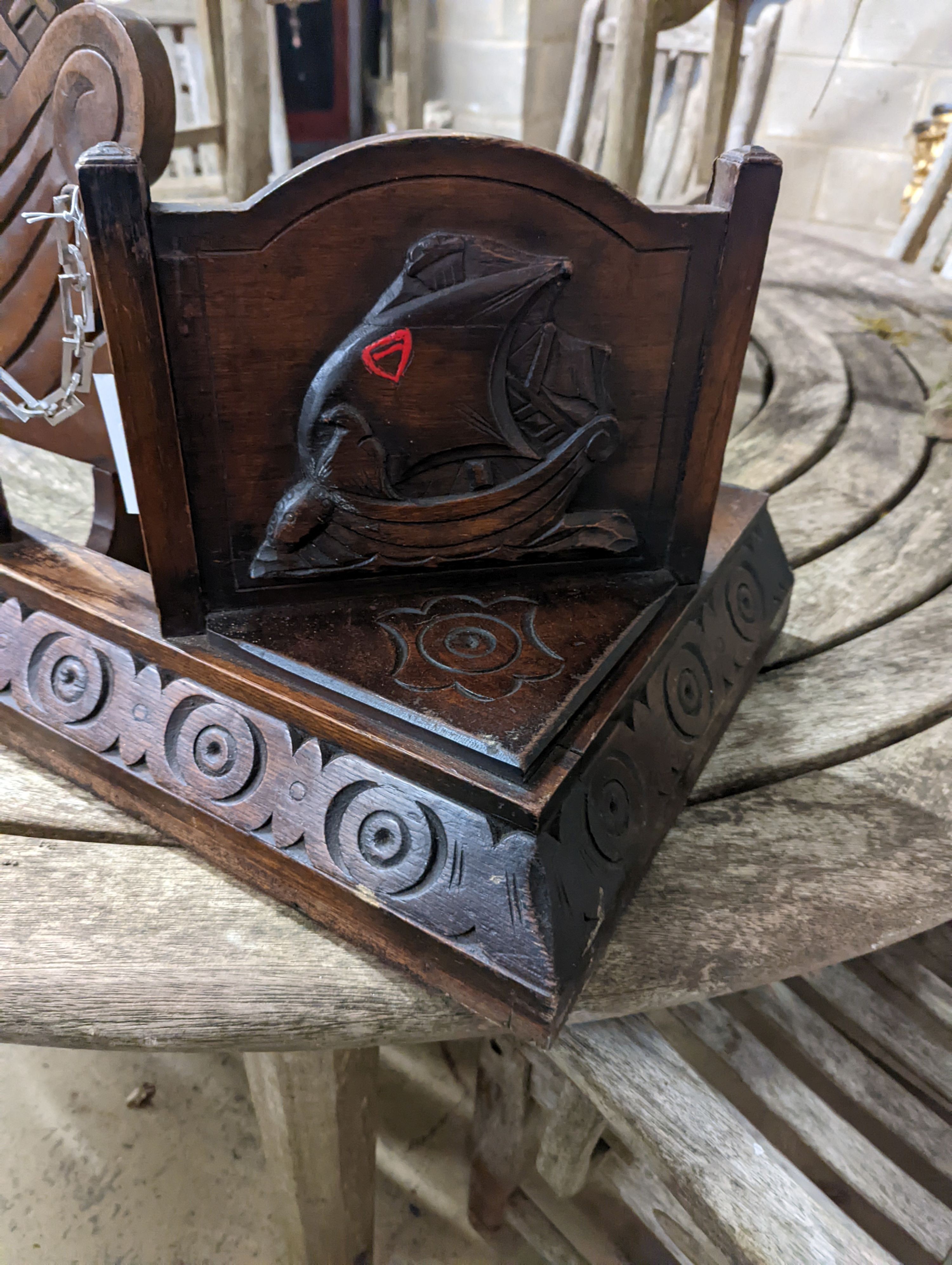 An early 20th century carved oak fender, length 124cm and a firescreen